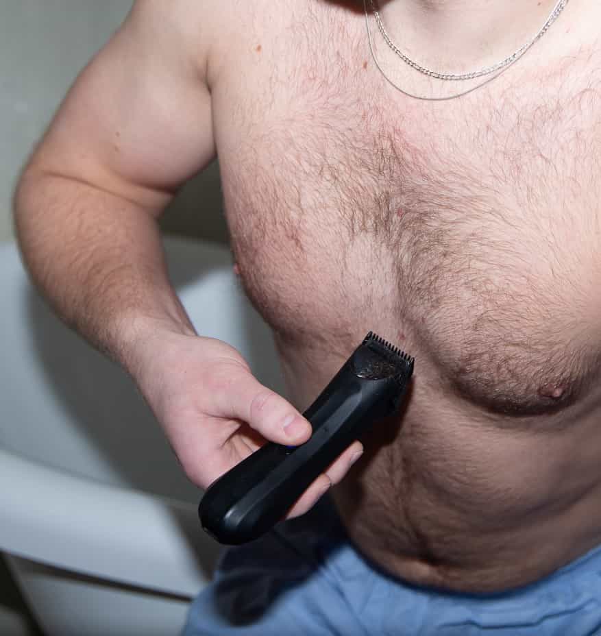 A man trimmer his chest with the Archibald Trimmer